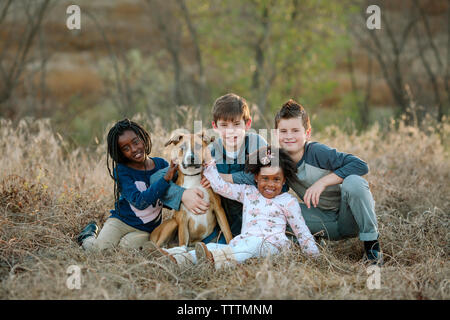 Family portrait - Family of four with a cute dog outdoors Stock Photo ...