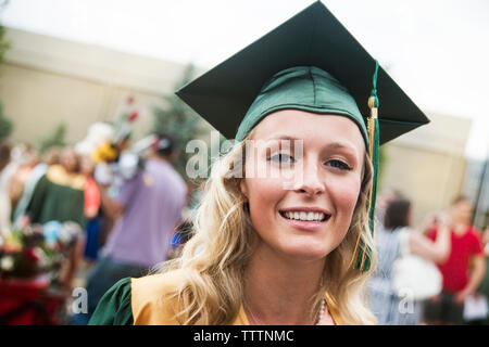 Portrait of woman with mortarboard at graduation ceremony