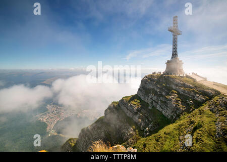 View of cross on mountain against sky Stock Photo