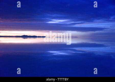 Reflection of mountain and clouds on the salt flat covered with water at dawn, Salar de Uyuni, Potosi Department, Bolivia Stock Photo