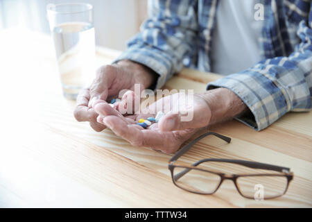 Senior man taking pills, closeup Stock Photo