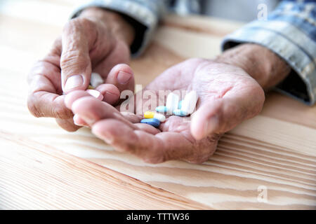Senior man taking pills, closeup Stock Photo