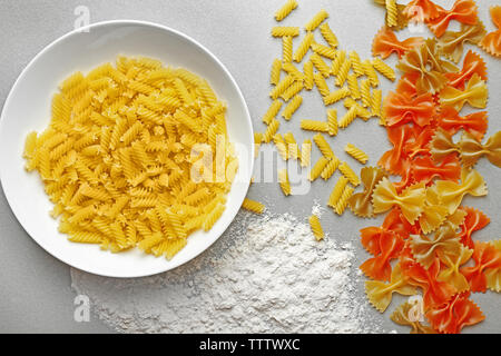 Plate with different kinds of pasta with cherry tomatoes on table Stock Photo