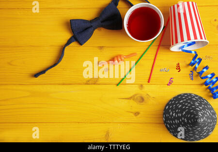Party accessories on yellow wooden background Stock Photo