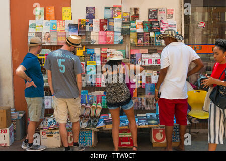 People looking at a booth selling books on the street, Cartagena, UNESCO World Heritage site, Bolivar Department, Colombia Stock Photo