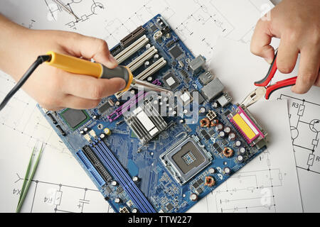 Man using soldering tool for motherboard repair, close up Stock Photo