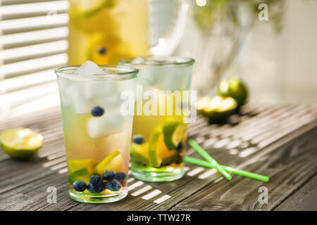 Fresh lemonade with lime and blueberry on windowsill Stock Photo