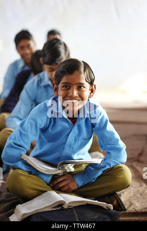 Boys sitting in a row in a classroom Stock Photo