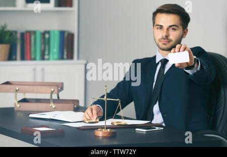 Handsome young man giving business card in modern office Stock Photo
