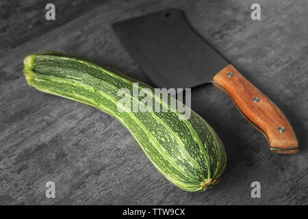 Fresh zucchini and knife on color background Stock Photo