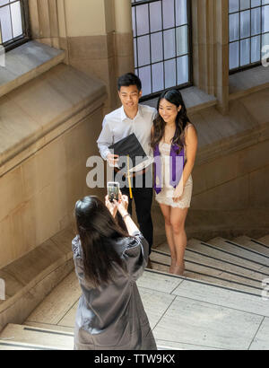 Asian family taking graduation photos on University of Washington Seattle campus, Seattle, Washington, USA Stock Photo