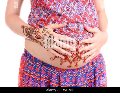 Harmless henna floral drawing art on boho pregnant woman tummy