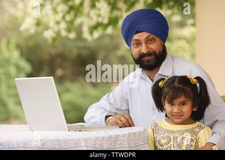 Portrait of a man with his daughter at a patio Stock Photo
