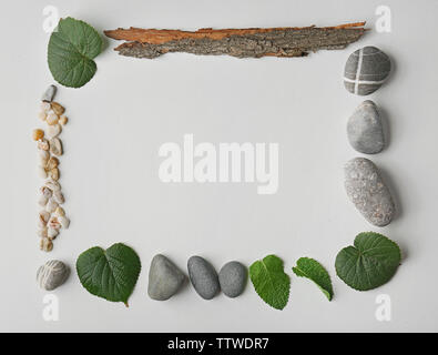 Rectangular frame made of pebbles, leaves and bark isolated on white Stock Photo
