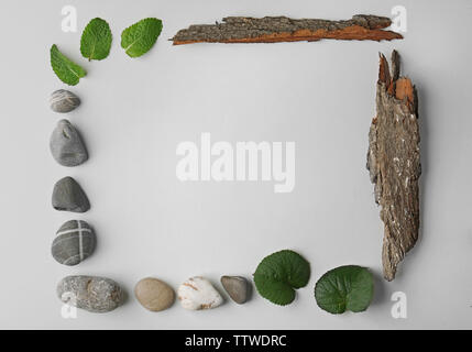 Rectangular frame made of pebbles, leaves and bark isolated on white Stock Photo