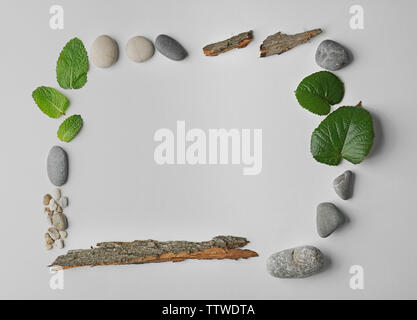 Rectangular frame made of pebbles, leaves and bark isolated on white Stock Photo