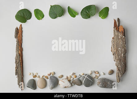 Rectangular frame made of pebbles, leaves and bark isolated on white Stock Photo