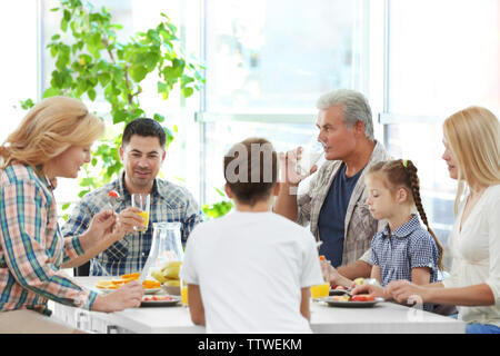 Happy large family having breakfast on kitchen Stock Photo