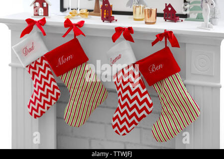 Christmas socks hanging on fireplace in room interior Stock Photo