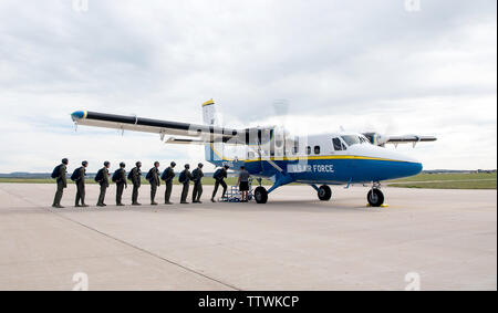 Cadets with parachutes, board a UV-18 B Twin Otter aircraft as part of the Airmanship 490 program (AM-490) on June 14, 2019 at the U.S. Air Force Academy airfield. AM-490, Basic Freefall Parachuting, is a training program where cadets must complete 5 parachute jumps to earn their jump wings following nearly 40 hours of ground training. It is the only certified program in the world where student’s very first jump is an unassisted freefall. (U.S. Air Force photo/Trevor Cokley) Stock Photo