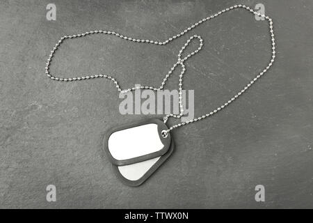 Military ID tags on dark background Stock Photo