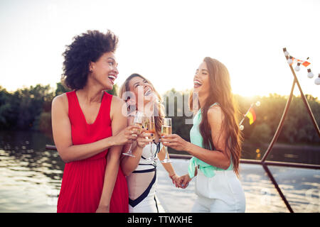 Group of happy friends drinking champagne and celebrating New Year Stock Photo