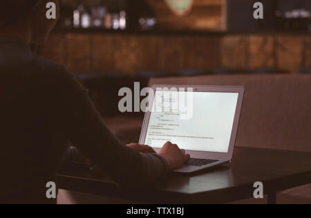 Woman working with laptop in cafe Stock Photo