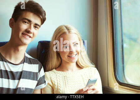 Young couple travelling by train Stock Photo