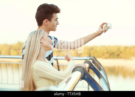 Beautiful young couple taking selfie outdoors Stock Photo