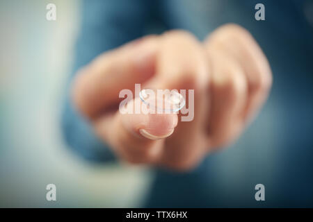Contact lens on female finger, close up view. Medicine and vision concept Stock Photo