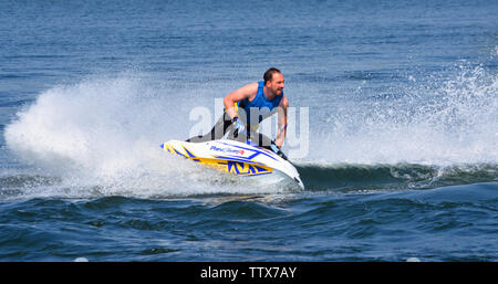 Freestyle Jet Skier performing 360  creating at lot of spray Stock Photo