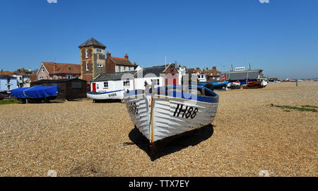 Aldeburgh beach with boats and old Lifeboat station with tower. Stock Photo