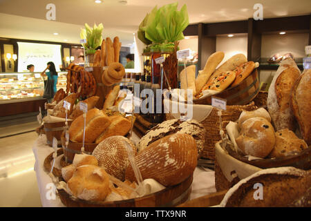 Assorted breads on a stall in a bakery, Bangkok, Thailand Stock Photo