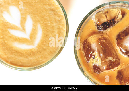 Cold ice latte and coffee with latte art in a glass on a white background. Top view. Stock Photo