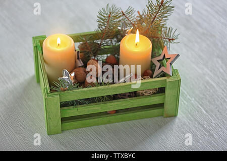 Green wooden box with Christmas decoration on table Stock Photo