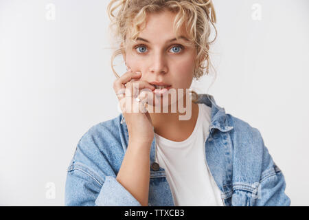 Sensuality, tenderness lifestyle concept. Attractive dreamy feminine blond blue-eyed girlfriend curly haircut open mouth flirty gazing camera touch Stock Photo