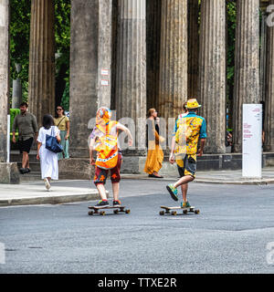 Young tourists in colourful clothing enjoying Summer, Museum Island, Mitte,Berlin. Two skate boarders Stock Photo