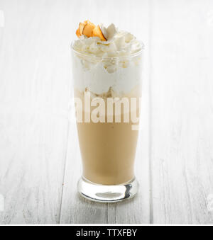 Coffee drinks with cream in glass on white wooden background Stock Photo