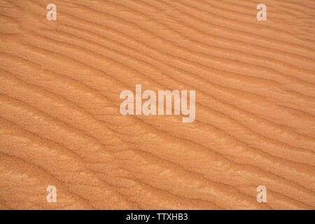 Beautiful Sand Texture background colorful orange shade desert sand dune pattern close up shot of desert sand waves Stock Photo