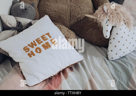 Comfortable pillows and toys of children lying on bed Stock Photo