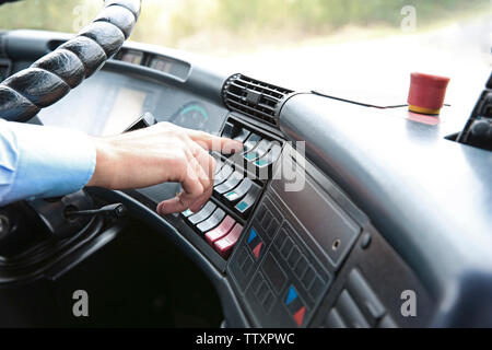 Bus driver  pushing button on panel Stock Photo