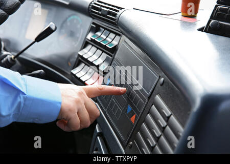Bus driver  pushing button on panel Stock Photo