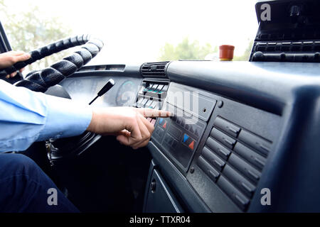 Bus driver  pushing button on panel Stock Photo