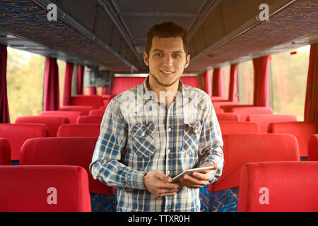 Conductor inside bus with clipboard Stock Photo