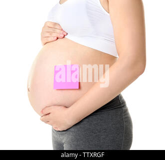 Closeup of pregnant woman's belly with sticker on white background Stock Photo