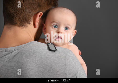 Military father holding his newborn baby Stock Photo