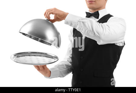 Male waiter holding cloche and tray on white background Stock Photo