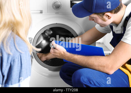 Plumber repairing washing machine Stock Photo