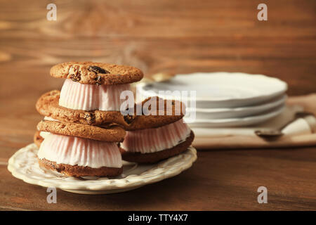 Ice cream cookie sandwiches on plate on table Stock Photo