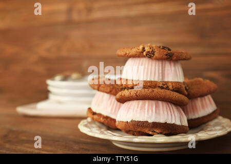 Ice cream cookie sandwiches on plate on table Stock Photo